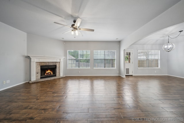 4025 S 217th E Ave, Broken Arrow, OK 74014 - unfurnished living room with plenty of natural light, a chandelier, a fireplace, and a ceiling fan