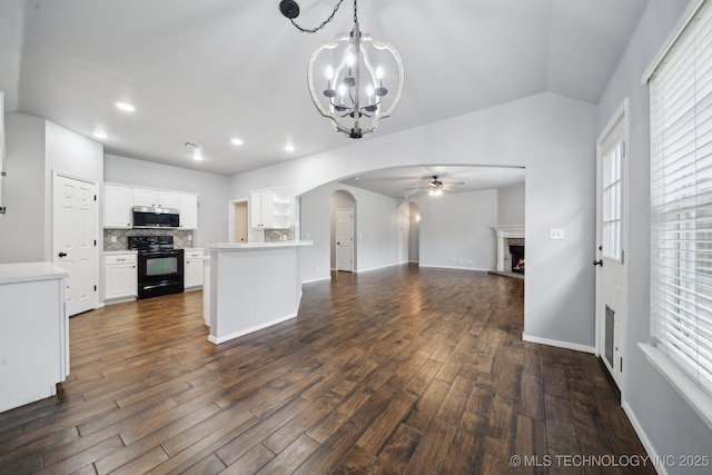 4025 S 217th E Ave, Broken Arrow, OK 74014 - kitchen featuring stainless steel microwave, black range with electric cooktop, ceiling fan, open floor plan, and arched walkways