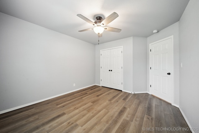 4025 S 217th E Ave, Broken Arrow, OK 74014 - unfurnished bedroom featuring wood finished floors, baseboards, a closet, and a ceiling fan