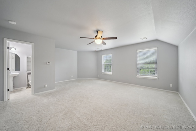 4025 S 217th E Ave, Broken Arrow, OK 74014 - unfurnished bedroom featuring light carpet, lofted ceiling, a sink, baseboards, and connected bathroom