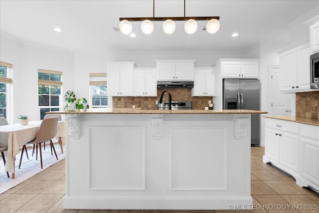 kitchen with appliances with stainless steel finishes, under cabinet range hood, light tile patterned floors, decorative backsplash, and white cabinetry