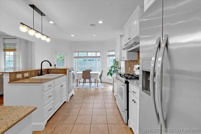 kitchen with stainless steel appliances, a sink, under cabinet range hood, white cabinetry, and light tile patterned floors