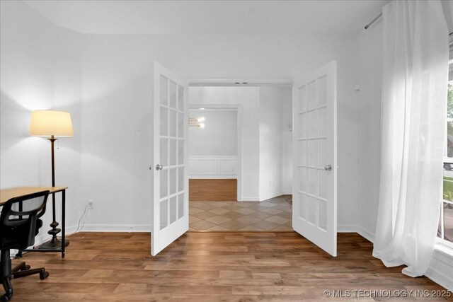 office area with french doors, wood finished floors, and baseboards