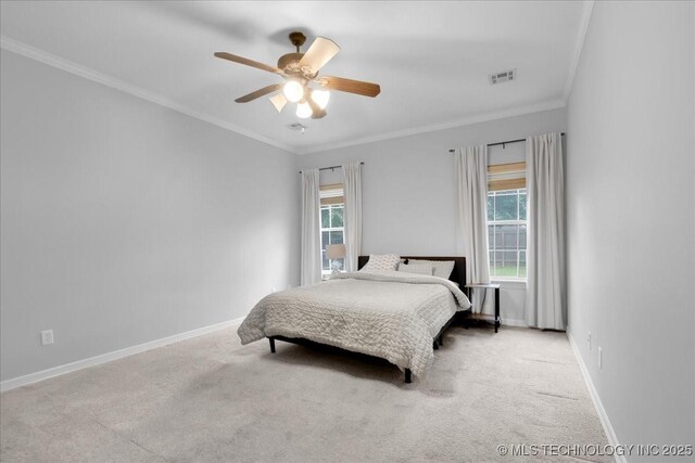 carpeted bedroom featuring multiple windows, crown molding, baseboards, and ceiling fan