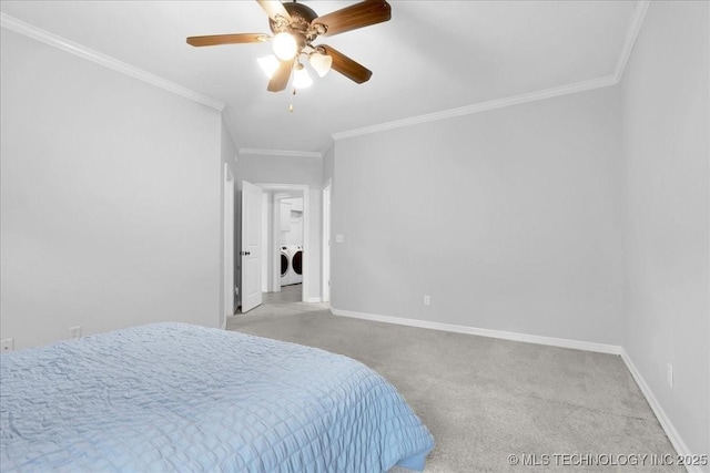 carpeted bedroom with separate washer and dryer, ornamental molding, baseboards, and ceiling fan