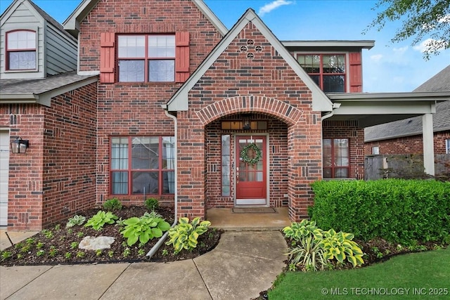 entrance to property featuring brick siding