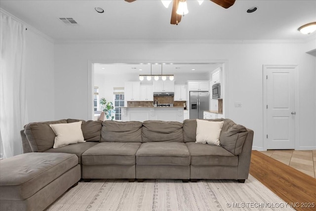 living area featuring a ceiling fan, crown molding, recessed lighting, and light tile patterned flooring