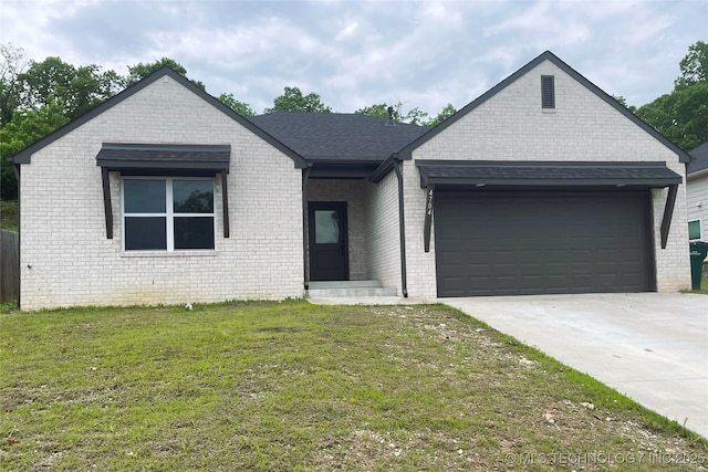 4704 S Linwood Dr, Sand Springs, OK 74063 - view of front facade featuring a garage, a front lawn, driveway, and brick siding