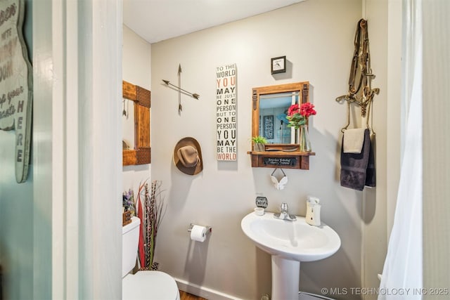 bathroom featuring toilet and a sink