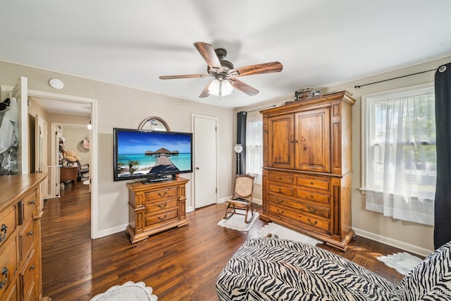 bedroom featuring baseboards, dark wood-type flooring, and ceiling fan