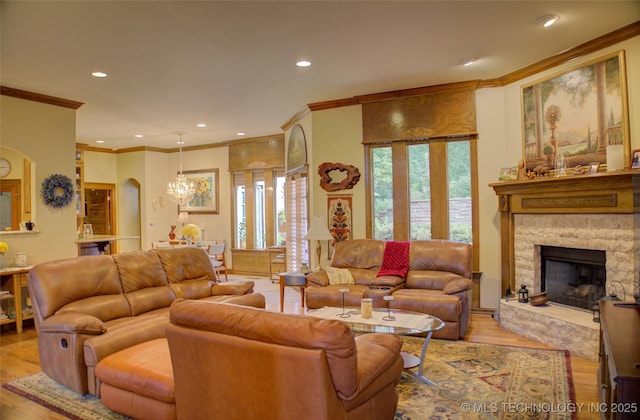 1310 N Northridge Ct, Sand Springs, OK 74063 - living area with crown molding, wood finished floors, recessed lighting, a fireplace, and arched walkways