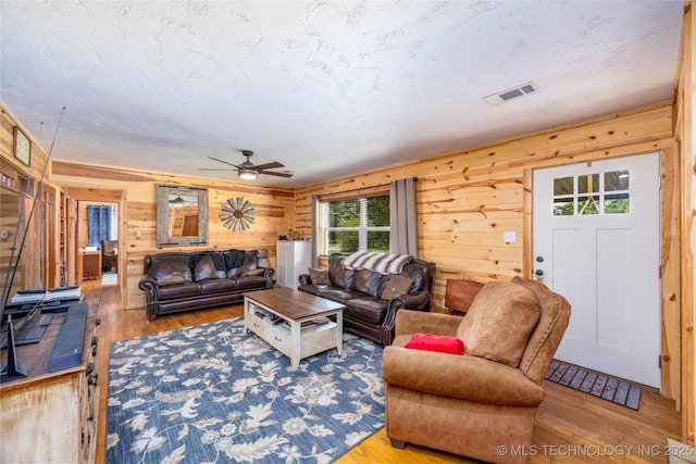 5700 S Wiley Rd, Milburn, OK 73450 - living area featuring ceiling fan, wood finished floors, and wood walls