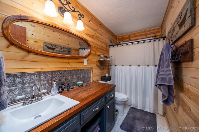 5700 S Wiley Rd, Milburn, OK 73450 - bathroom with toilet, vanity, a shower with curtain, and wood walls
