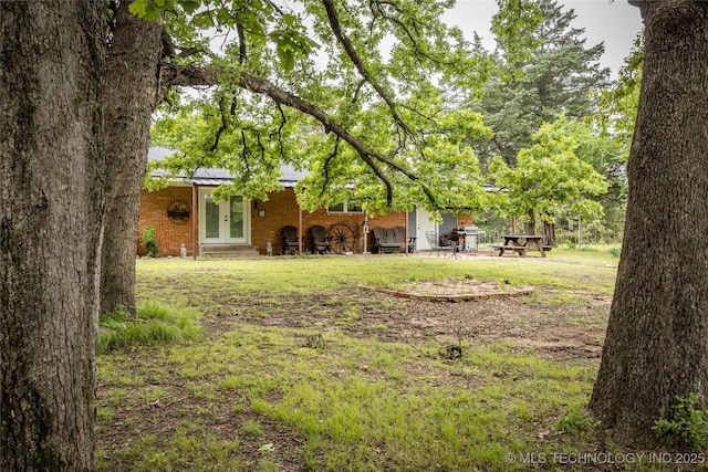5700 S Wiley Rd, Milburn, OK 73450 - view of green lawn with french doors