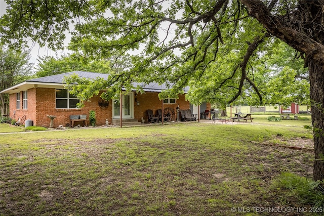 5700 S Wiley Rd, Milburn, OK 73450 - back of house with brick siding, a lawn, french doors, and entry steps