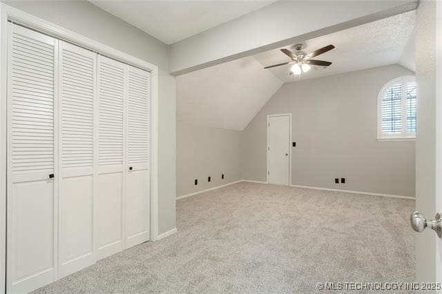 bonus room with a ceiling fan, vaulted ceiling, carpet floors, and baseboards