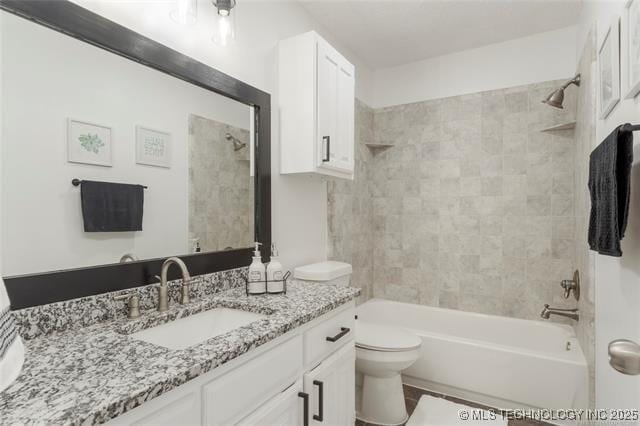 bathroom featuring toilet, bathtub / shower combination, and vanity