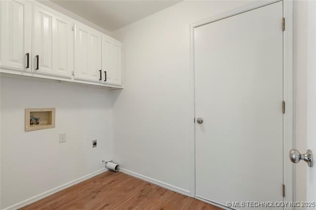 laundry area with washer hookup, electric dryer hookup, cabinet space, light wood-style flooring, and baseboards