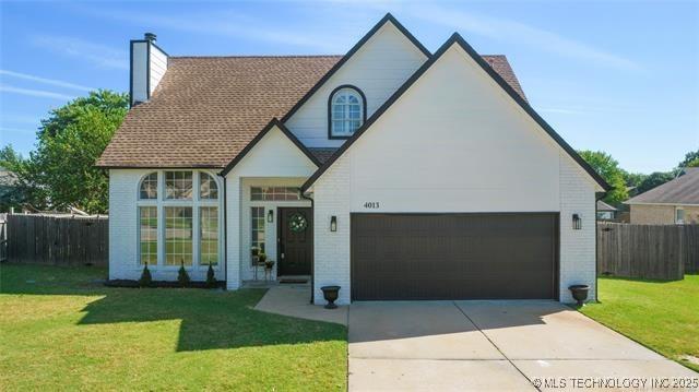 4013 S Poplar Ave, Broken Arrow, OK 74011 - view of front of property with a chimney, concrete driveway, and brick siding