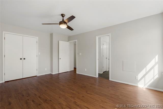 unfurnished bedroom with wood finished floors and baseboards