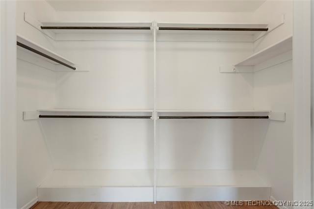 spacious closet featuring wood finished floors
