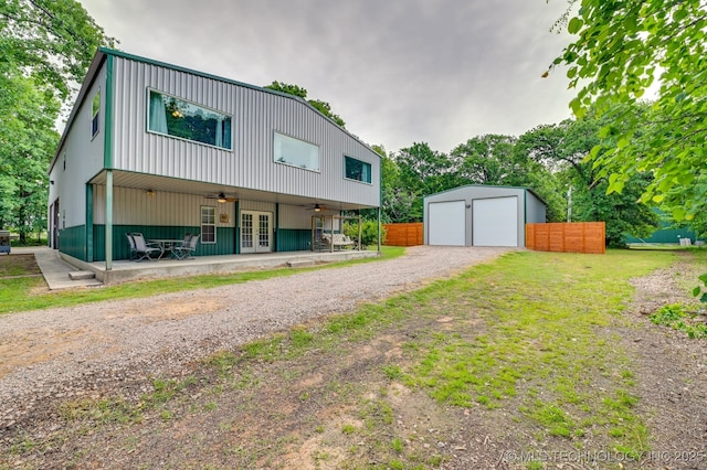 1694 Boat Ramp Rd, Kingston, OK 73439 - view of front facade with french doors, fence, a detached garage, an outbuilding, and a ceiling fan