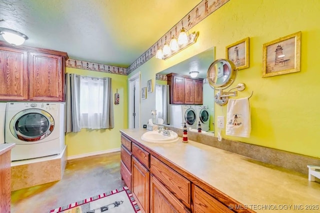 1694 Boat Ramp Rd, Kingston, OK 73439 - bathroom with washing machine and clothes dryer, vanity, a textured ceiling, and baseboards
