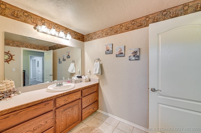 1694 Boat Ramp Rd, Kingston, OK 73439 - bathroom featuring a textured ceiling, tile patterned floors, vanity, and baseboards