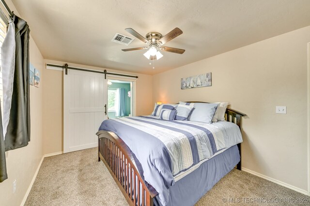 1694 Boat Ramp Rd, Kingston, OK 73439 - carpeted bedroom featuring baseboards, a ceiling fan, and a barn door