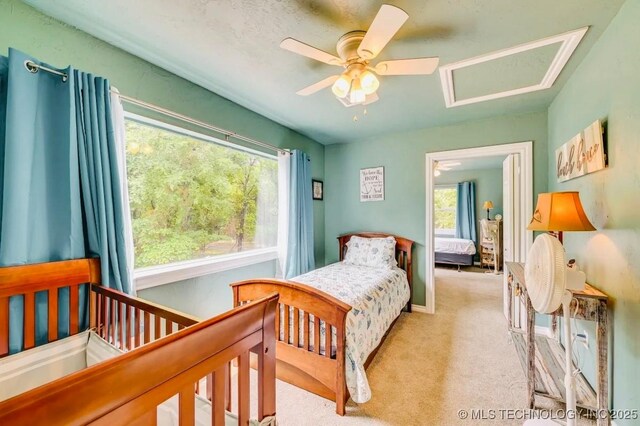 1694 Boat Ramp Rd, Kingston, OK 73439 - carpeted bedroom featuring multiple windows, attic access, and a ceiling fan