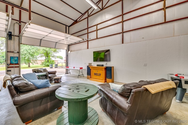 1694 Boat Ramp Rd, Kingston, OK 73439 - living area with a garage, a towering ceiling, and concrete flooring