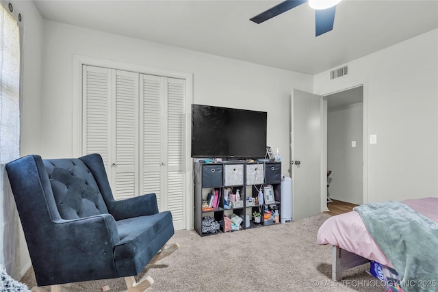 carpeted bedroom featuring a closet and a ceiling fan