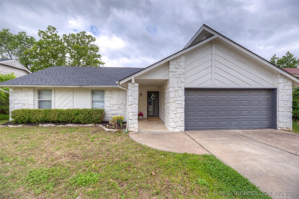 3010 S Narcissus Pl, Broken Arrow, OK 74012 - single story home featuring stone siding, roof with shingles, an attached garage, concrete driveway, and a front yard