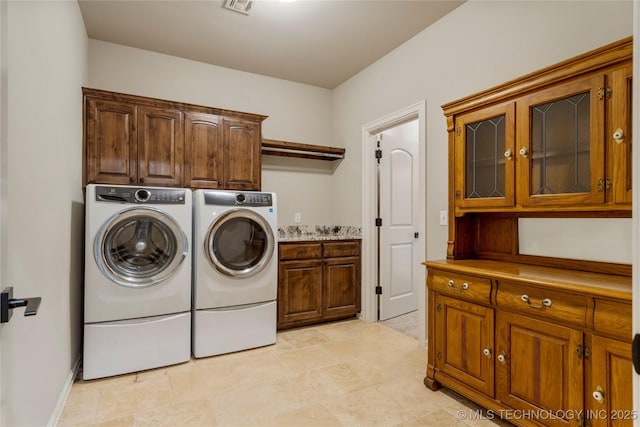 washroom with cabinet space and independent washer and dryer