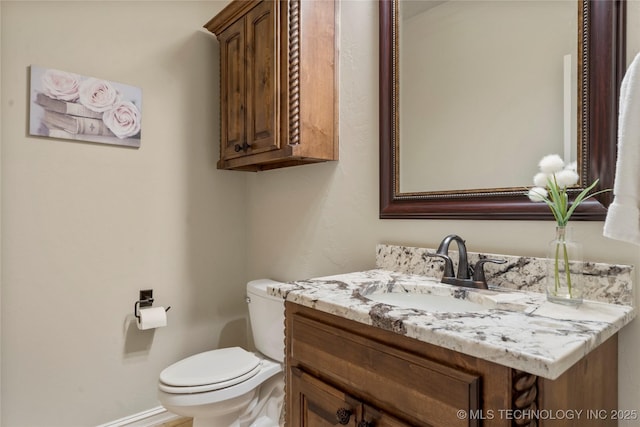 half bathroom featuring toilet and vanity