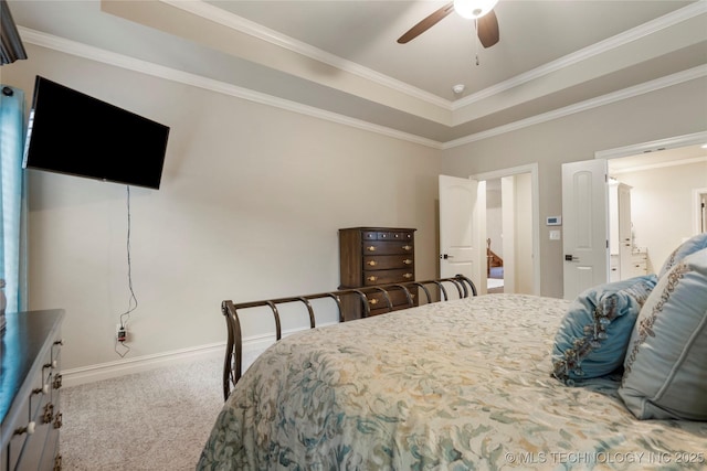 bedroom with carpet, ornamental molding, baseboards, a raised ceiling, and ceiling fan