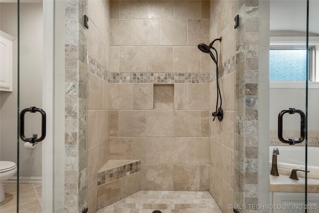 bathroom featuring a stall shower and toilet