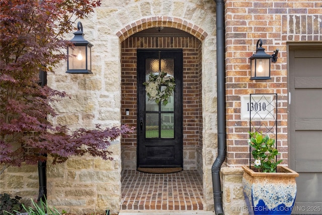 doorway to property with brick siding