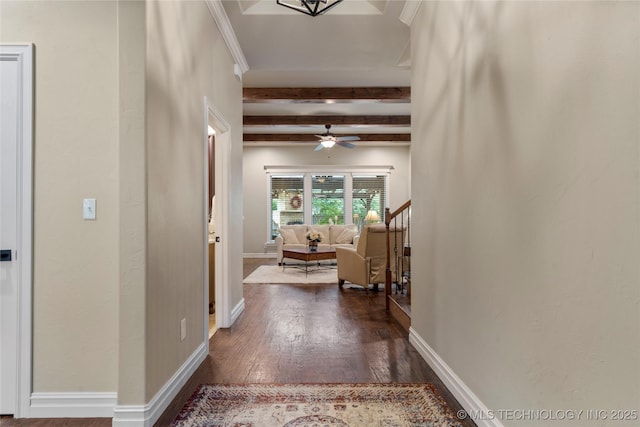 hallway featuring beamed ceiling, dark wood-style floors, and baseboards