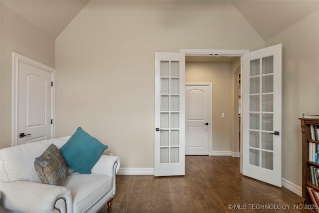 living area featuring french doors, vaulted ceiling, wood finished floors, and baseboards