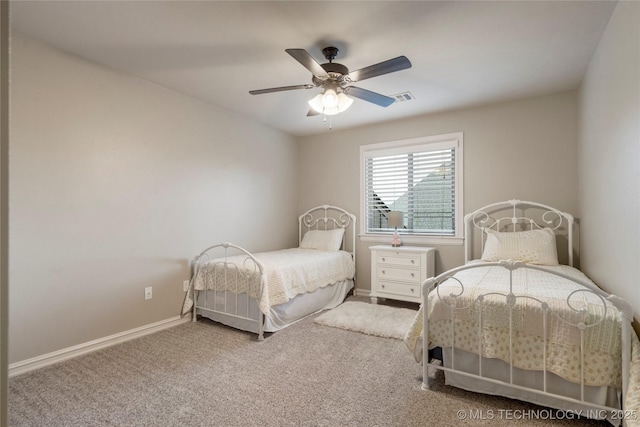 carpeted bedroom featuring baseboards and ceiling fan