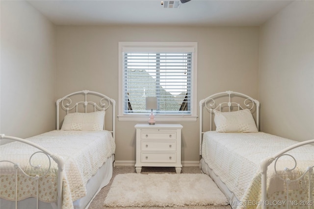 bedroom featuring carpet floors and baseboards