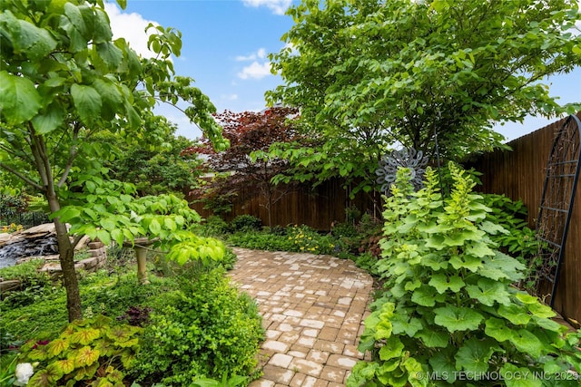 fenced backyard with a patio area