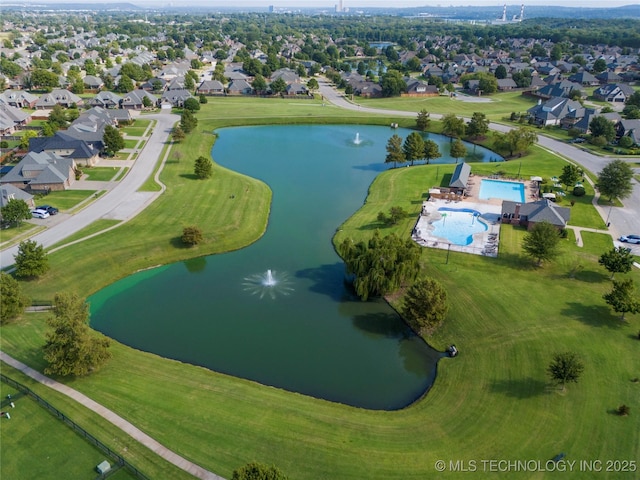 aerial view of property's location with a nearby body of water, a pool area, and nearby suburban area