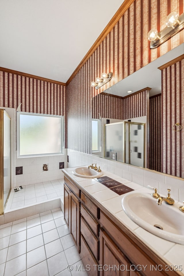 full bath with wallpapered walls, a shower stall, tile patterned flooring, and double vanity