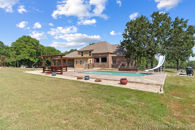 swimming pool with a water slide, a patio area, a yard, a pergola, and a grill