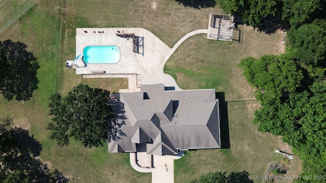 aerial view of property and surrounding area featuring a pool