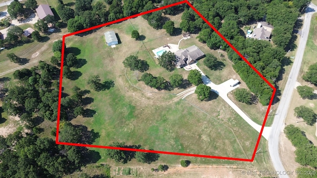 aerial view of property and surrounding area featuring property parcel outlined