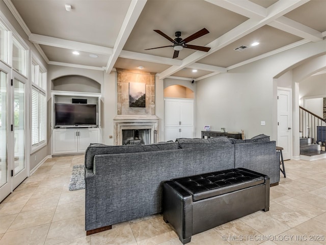 3661 S Lewis Ave, Tulsa, OK 74105 - living room with coffered ceiling, arched walkways, a ceiling fan, a fireplace, and beam ceiling