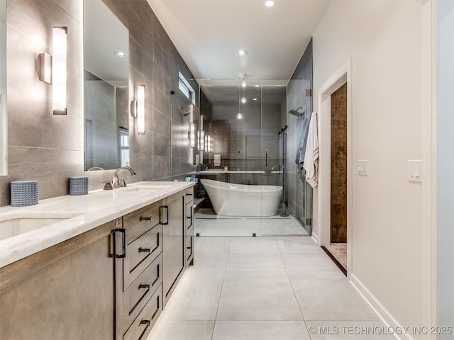 3661 S Lewis Ave, Tulsa, OK 74105 - bathroom featuring tile walls, double vanity, tiled shower, tile patterned floors, and a soaking tub